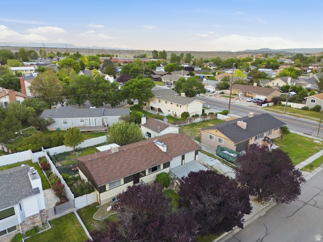 822 Pinewood Circle Price, UT 84501 - Photo 46 of 49 Residential aerial view of the neighborhood featuring a paved street, mature trees, and single-family homes.