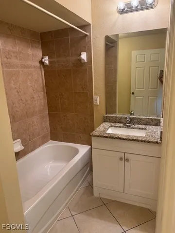 a bathroom with a granite countertop sink a toilet and shower