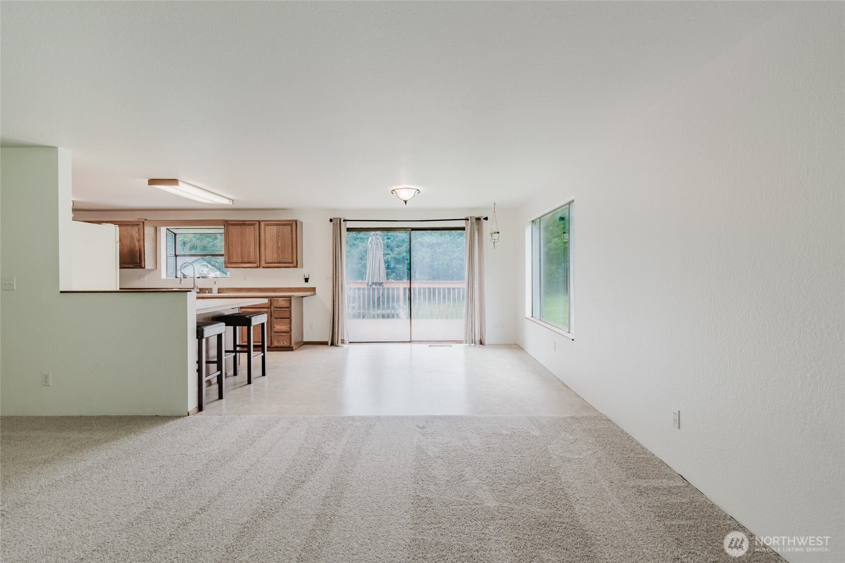 41 Meadowood Drive Elma, WA 98541 - Photo 9 of 40 an empty room with a fireplace and windows