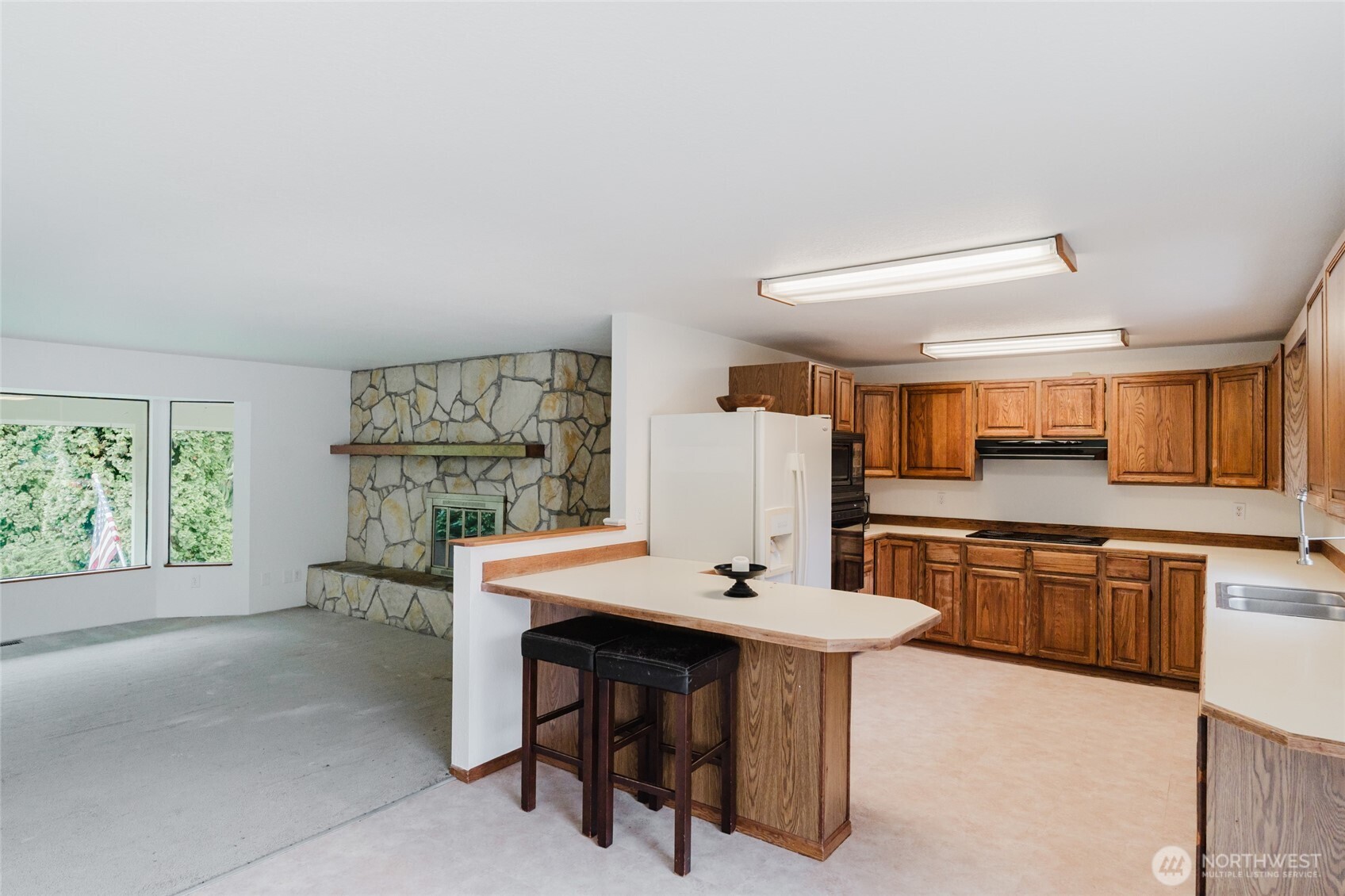 41 Meadowood Drive Elma, WA 98541 - Photo 10 of 40 a kitchen with stainless steel appliances kitchen island granite countertop a sink stove and refrigerator