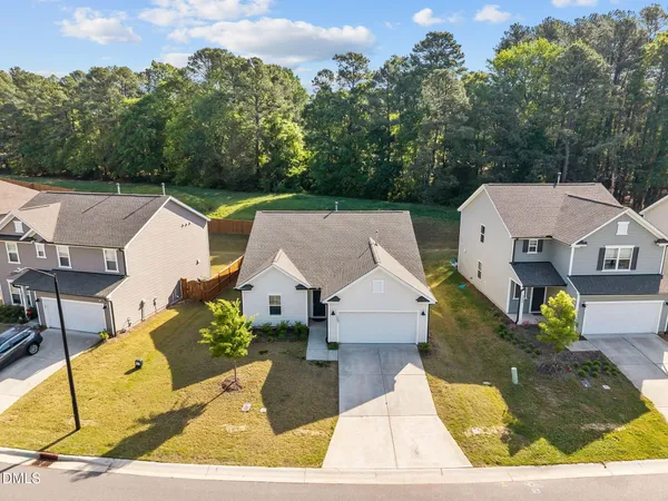 an aerial view of a house with swimming pool and sitting area