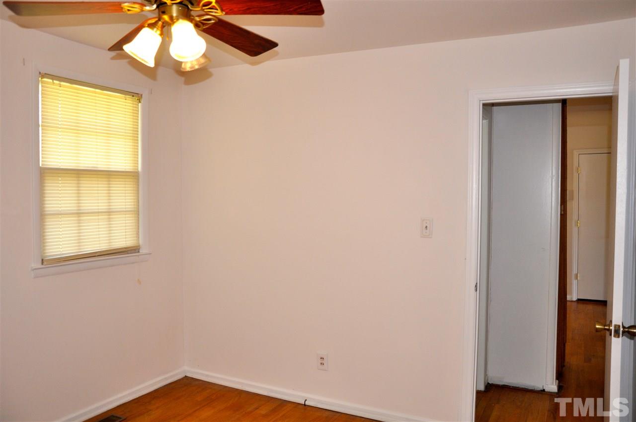 819 Hadley Road Raleigh, NC 27610 - Photo 14 of 20 a view of empty room with window and wooden floor
