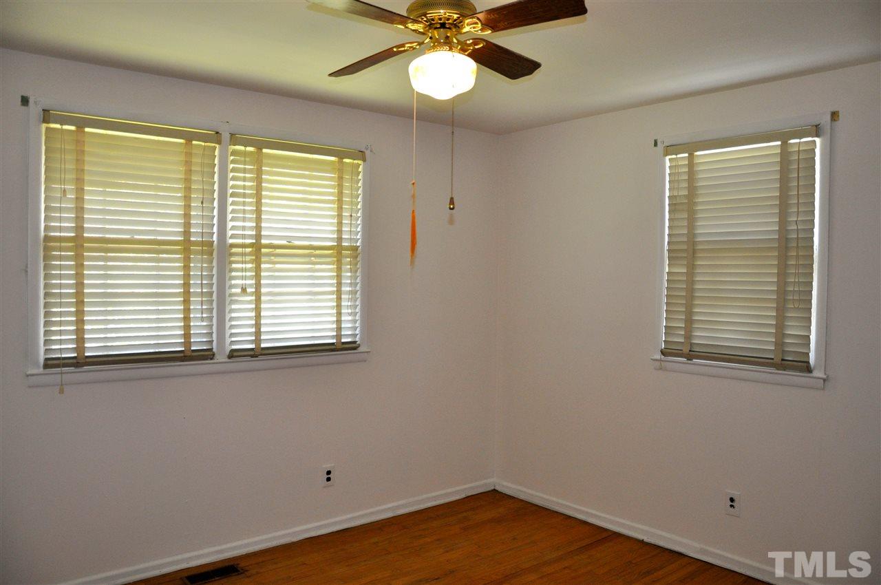 819 Hadley Road Raleigh, NC 27610 - Photo 15 of 20 a view of a room with wooden floor and a window