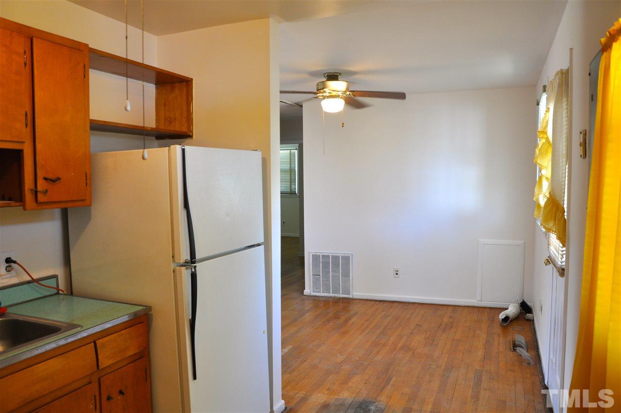 819 Hadley Road Raleigh, NC 27610 - Photo 8 of 20 a view of a kitchen with a refrigerator and cabinets