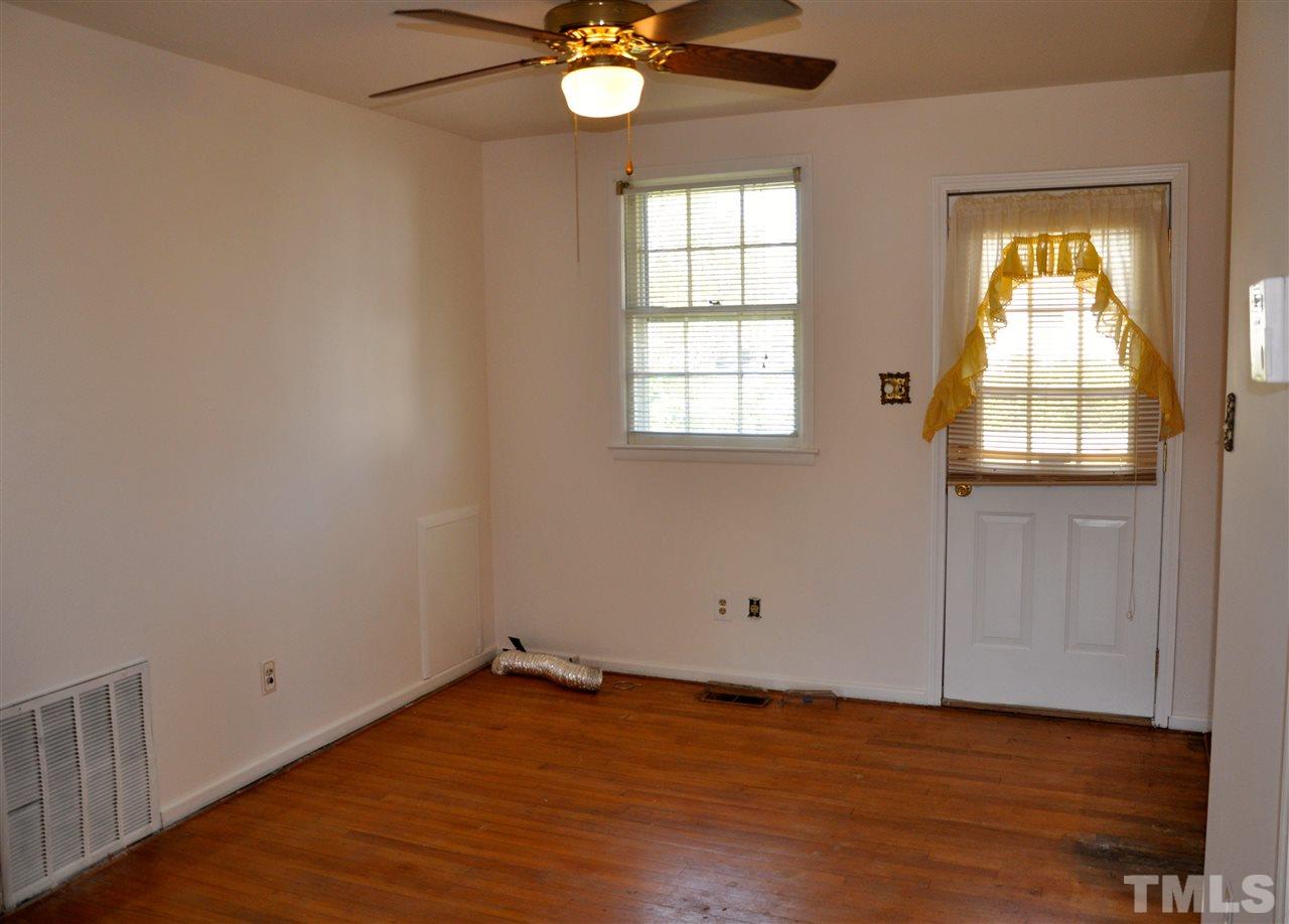 819 Hadley Road Raleigh, NC 27610 - Photo 9 of 20 an empty room with wooden floor and windows