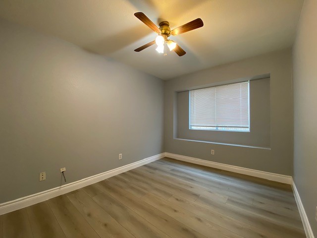 1512 Lorson Loop Round Rock, TX 78665 - Photo 28 of 29 an empty room with wooden floor and windows