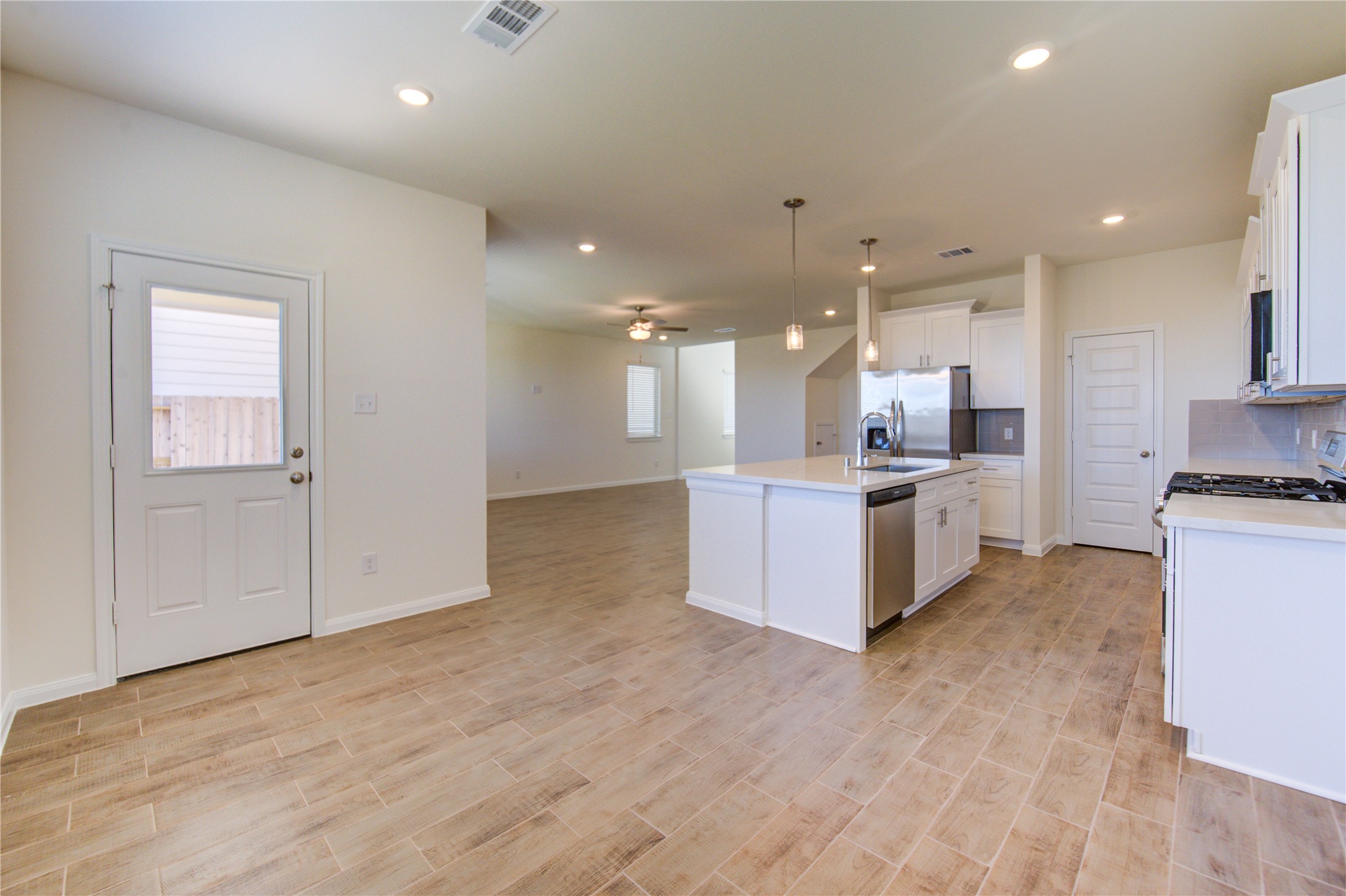 21707 Cypress Trellis Drive Cypress, TX 77433 - Photo 11 of 24 a view of kitchen with kitchen island wooden floor center island and stainless steel appliances