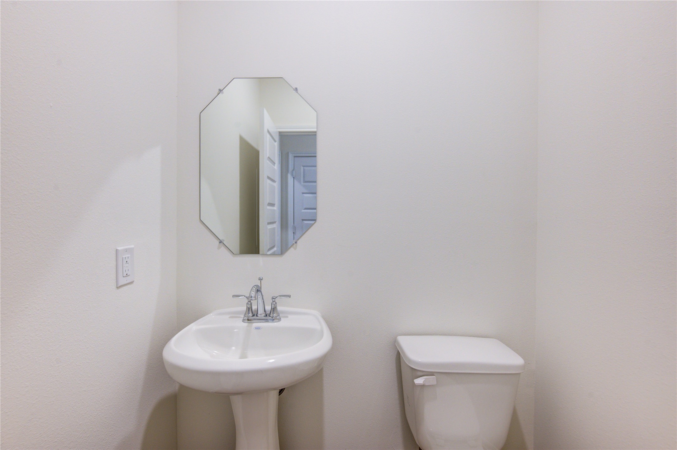 21707 Cypress Trellis Drive Cypress, TX 77433 - Photo 13 of 24 a bathroom with a toilet sink and mirror