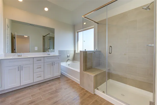 a bathroom with a bathtub and shower