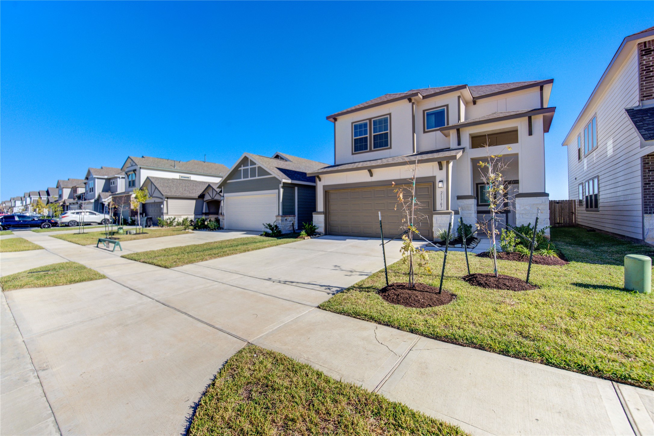 21707 Cypress Trellis Drive Cypress, TX 77433 - Photo 2 of 24 a front view of a house with a yard and potted plants