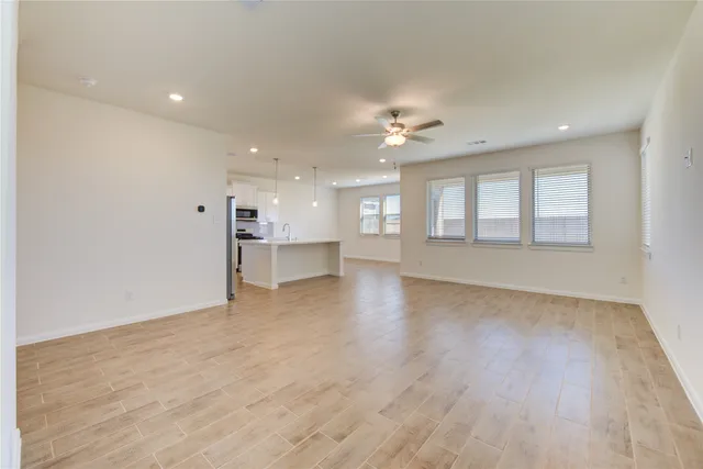 a view of kitchen with stainless steel appliances refrigerator stove microwave and cabinets