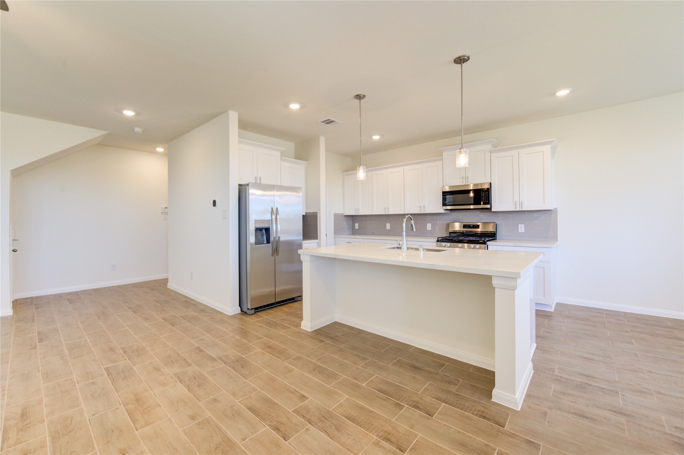 21707 Cypress Trellis Drive Cypress, TX 77433 - Photo 6 of 24 a view of kitchen with stainless steel appliances refrigerator stove microwave and cabinets