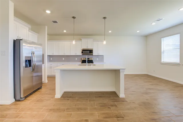 a kitchen with a sink stove and cabinets