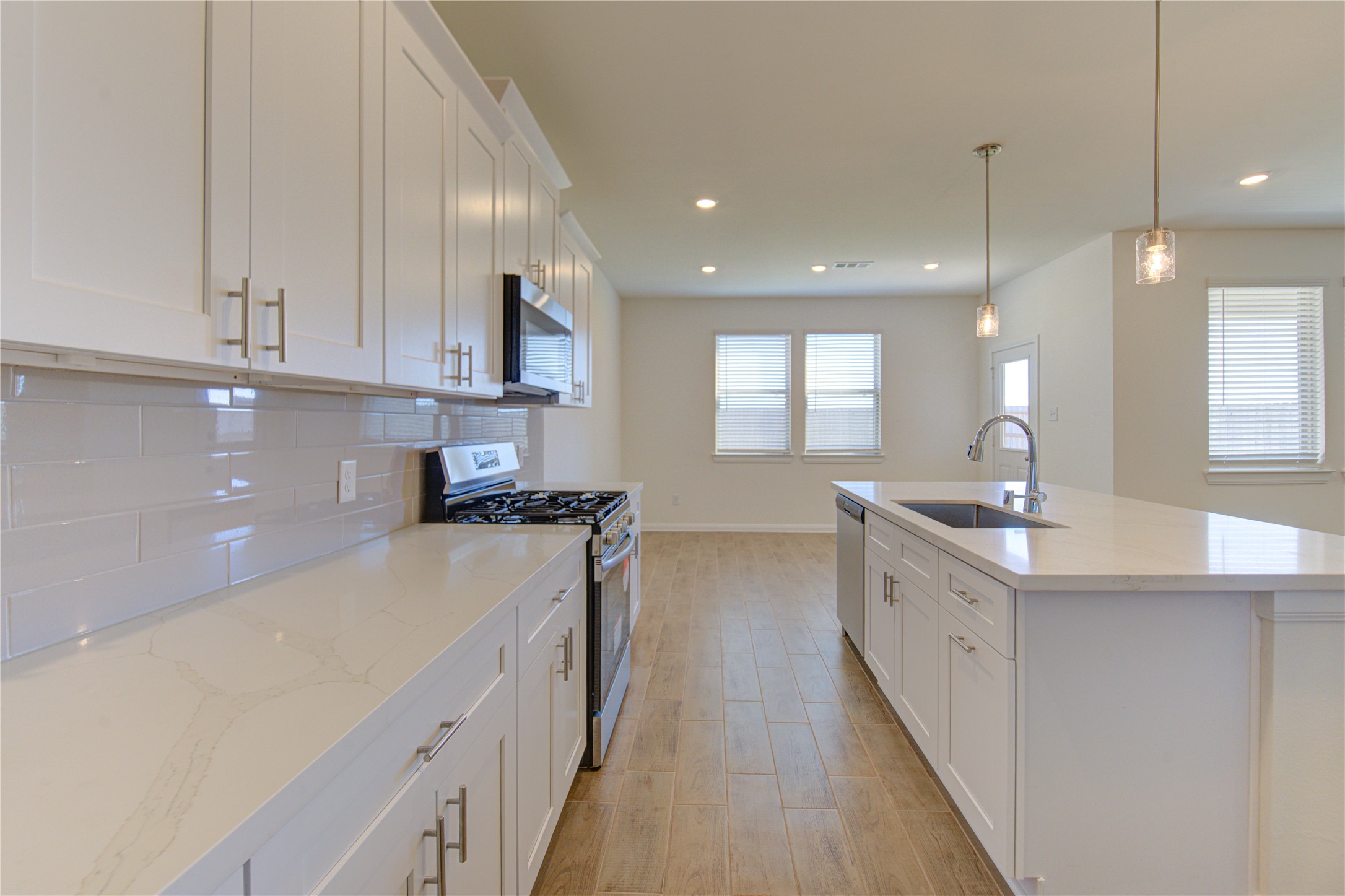 21707 Cypress Trellis Drive Cypress, TX 77433 - Photo 9 of 24 a kitchen with a sink stove and cabinets