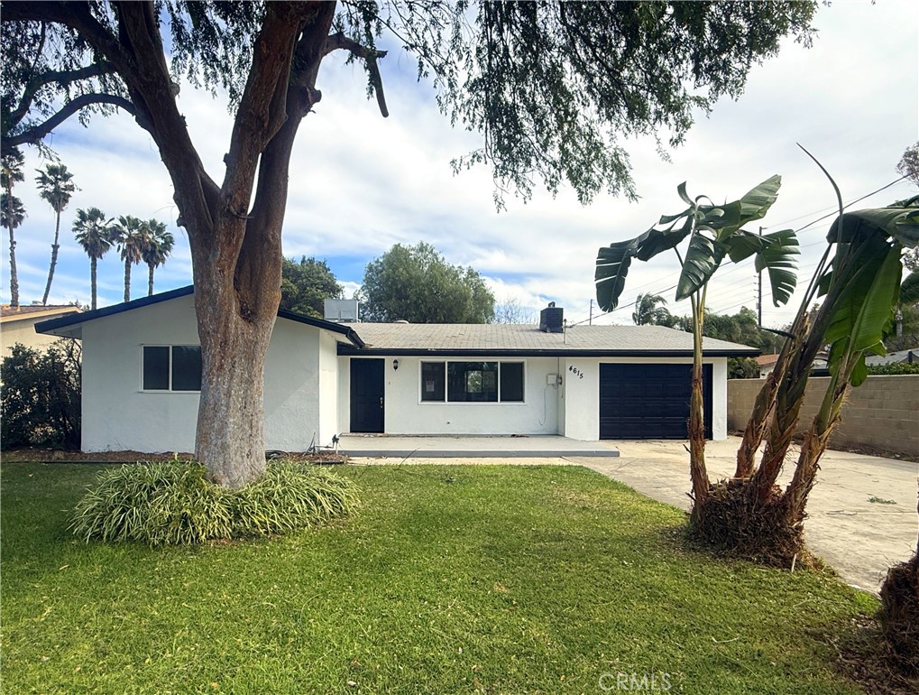 4615 Mobley Avenue Riverside, CA 92505 - Photo 1 of 1 a front view of house with yard and trees