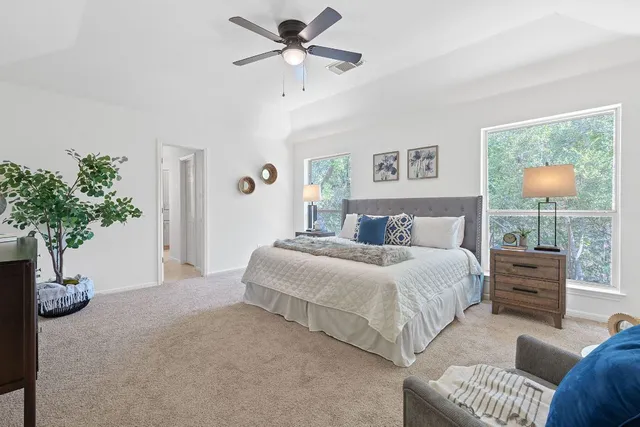 a bedroom with a bed and ceiling fan