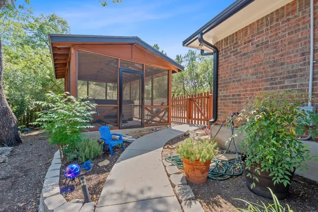 a view of a house with backyard and sitting area
