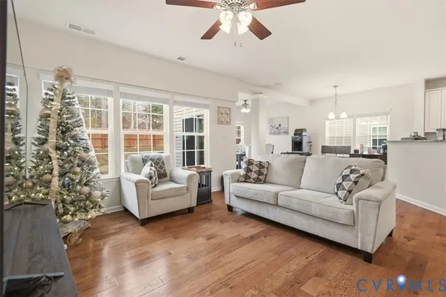a view of a living room kitchen with furniture and wooden floor