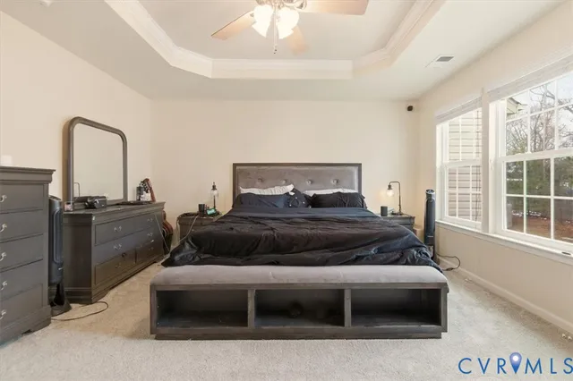a bedroom with a bed next to a large window with kitchen view