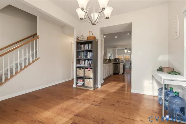 a kitchen with stainless steel appliances granite countertop a refrigerator sink and white cabinets