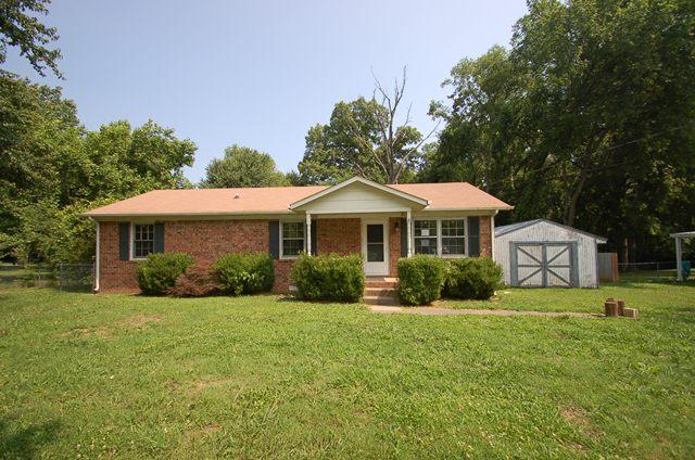 Spacious all brick ranch style home on large lot with fenced yard and multiple storage units!