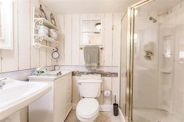 a bathroom with a granite countertop toilet sink and shower
