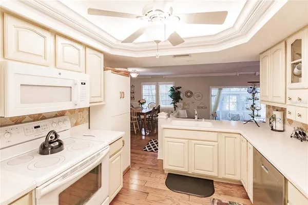 a kitchen with a sink appliances and cabinets