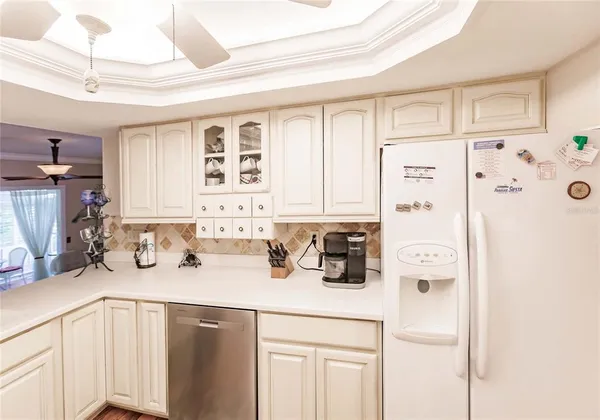 a kitchen with stainless steel appliances a sink a refrigerator and cabinets