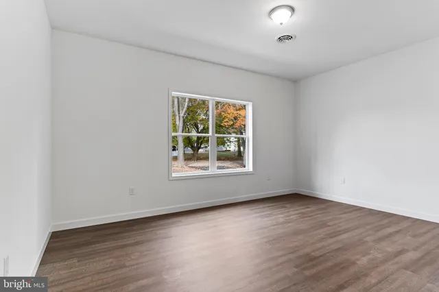 an empty room with wooden floor
