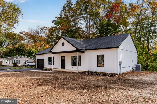 a view of a white house with a yard