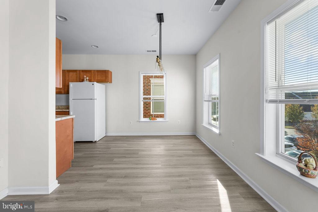 3542 Worthington Boulevard, Unit 301 Frederick, MD 21704 - Photo 1 of 22 a view of empty room with wooden floor and fan
