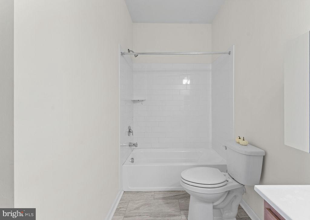 3542 Worthington Boulevard, Unit 301 Frederick, MD 21704 - Photo 16 of 22 a bathroom with a shower a toilet and a sink