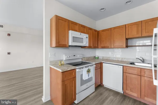 a kitchen with stainless steel appliances granite countertop a sink stove and cabinets