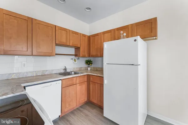 a white refrigerator freezer sitting inside of a kitchen