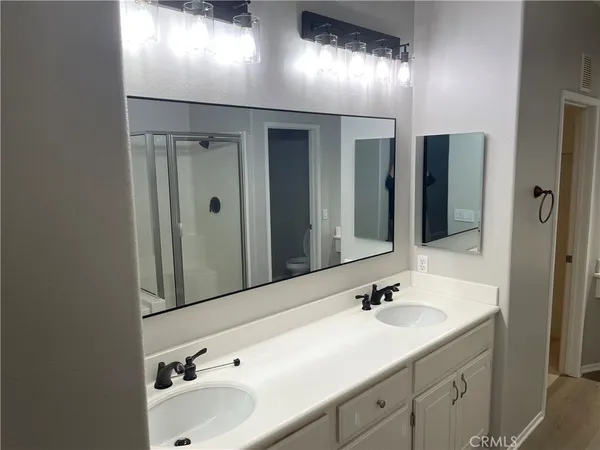 a bathroom with a double vanity sink and mirror