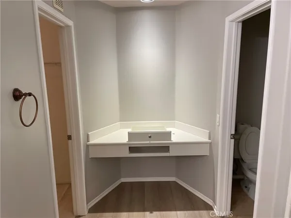 a bathroom with a granite countertop white toilet and a sink