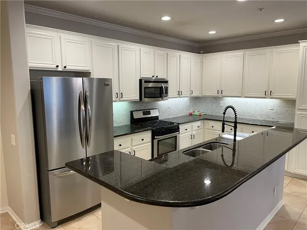 a kitchen with stainless steel appliances granite countertop a sink and cabinets