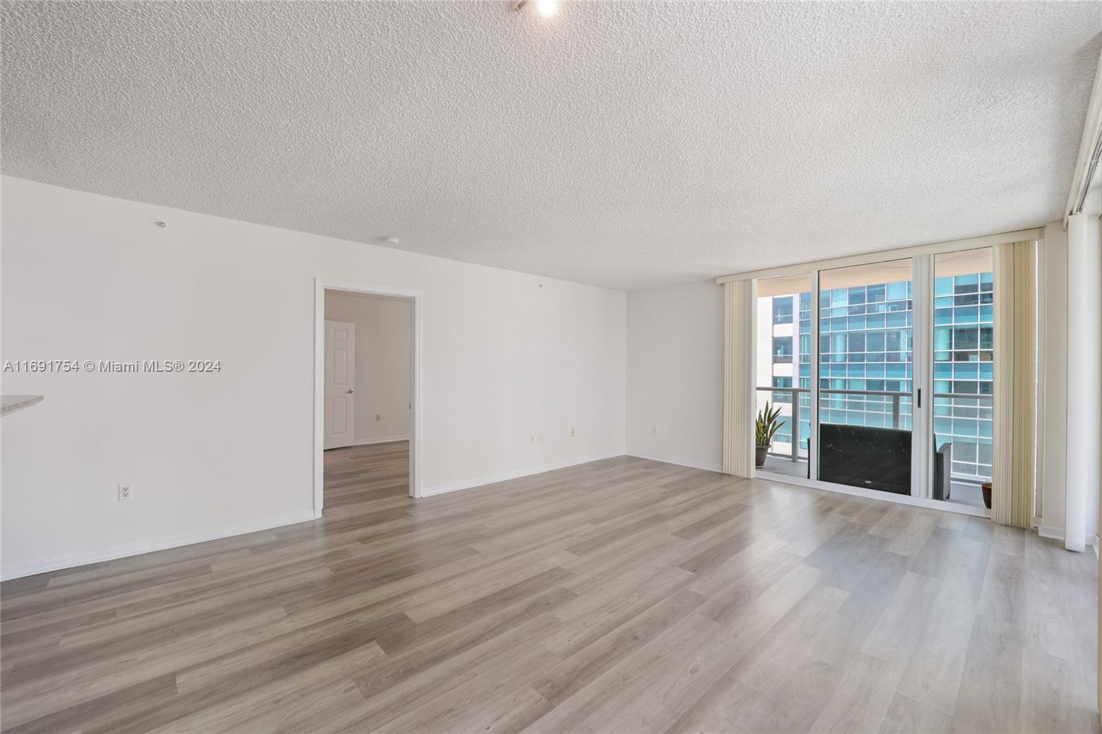 Brickell Miami, FL 33131 - Photo 3 of 14 a view of an empty room with wooden floor and a window