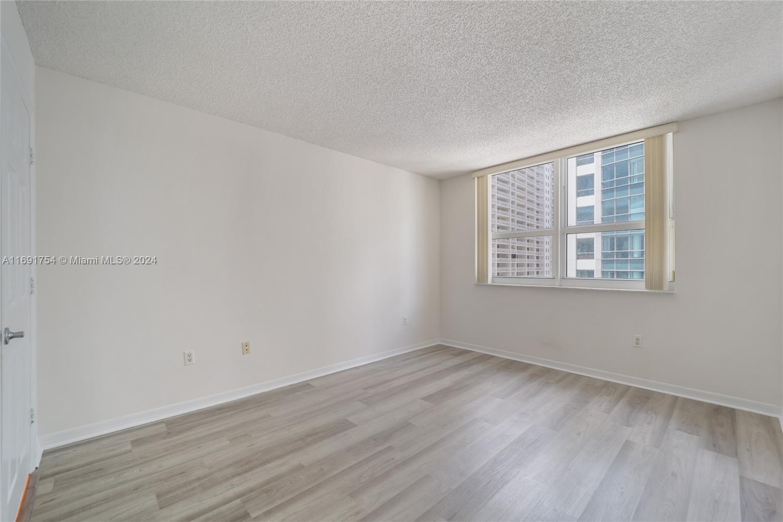 Brickell Miami, FL 33131 - Photo 8 of 14 wooden floor in an empty room with a window
