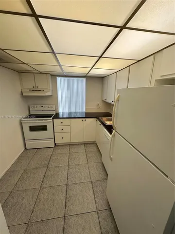 a view of a kitchen with a sink and dishwasher