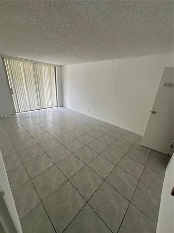 an empty room with a carpet