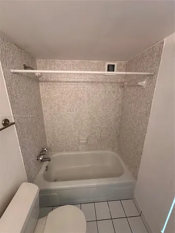 a bathroom with a shower and toilet