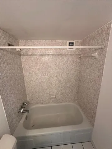 a bathroom with a shower and toilet