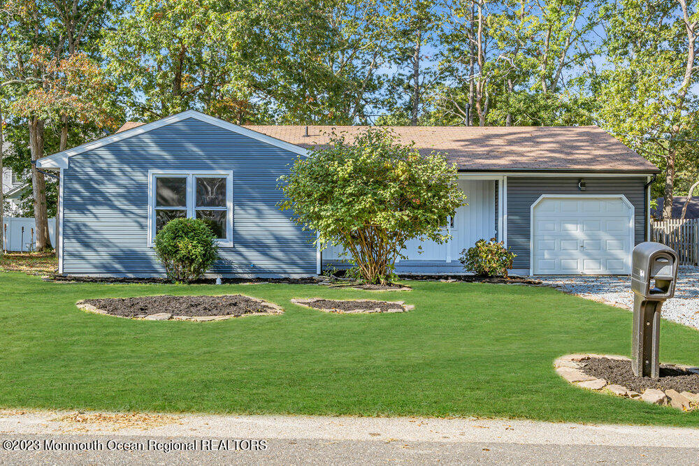 164 Stowaway Road Manahawkin, NJ 08050 - Photo 1 of 1 a front view of a house with garden