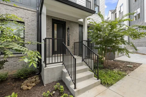 a view of a house with a small yard and plants