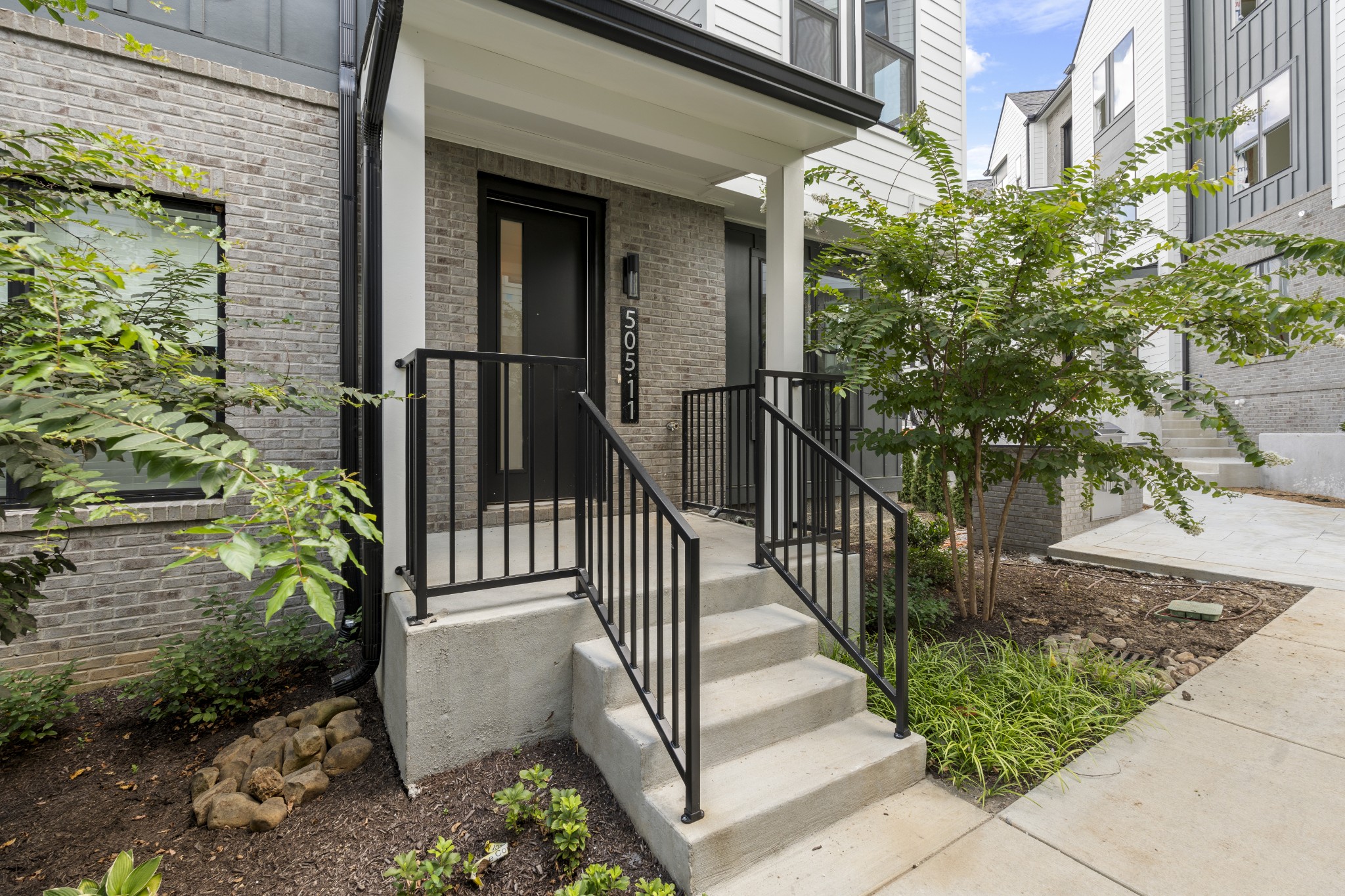 a view of a house with a small yard and plants