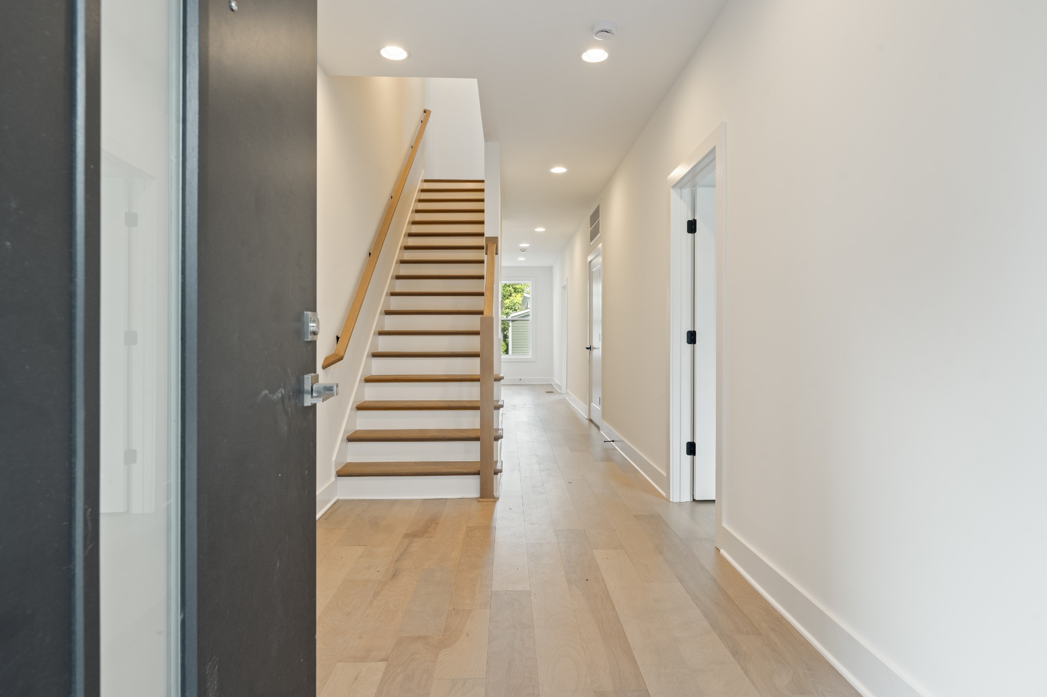 505 Community Court, Unit 11 Nashville, TN 37209 - Photo 12 of 37 a view of a hallway with stairs and a white wooden floor