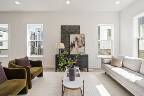 a living room with furniture and a mirror