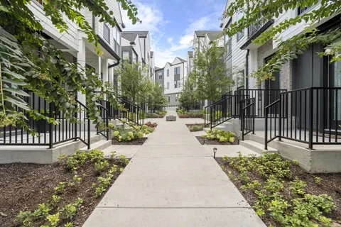 a view of a pathway with a garden