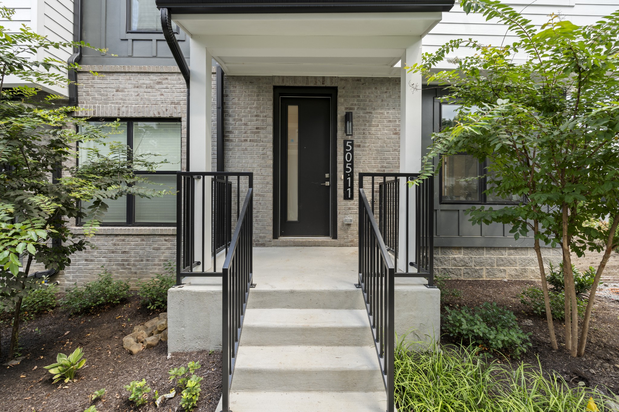 505 Community Court, Unit 11 Nashville, TN 37209 - Photo 3 of 37 a front view of a house with a tree in front
